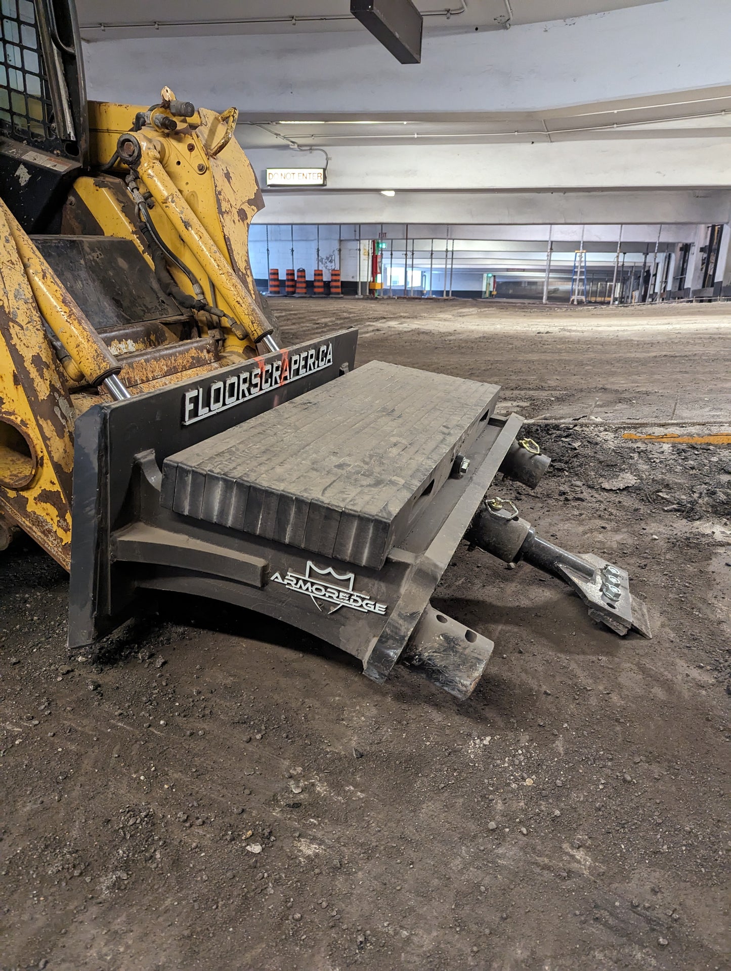 XDS floor scraper on a skidsteer